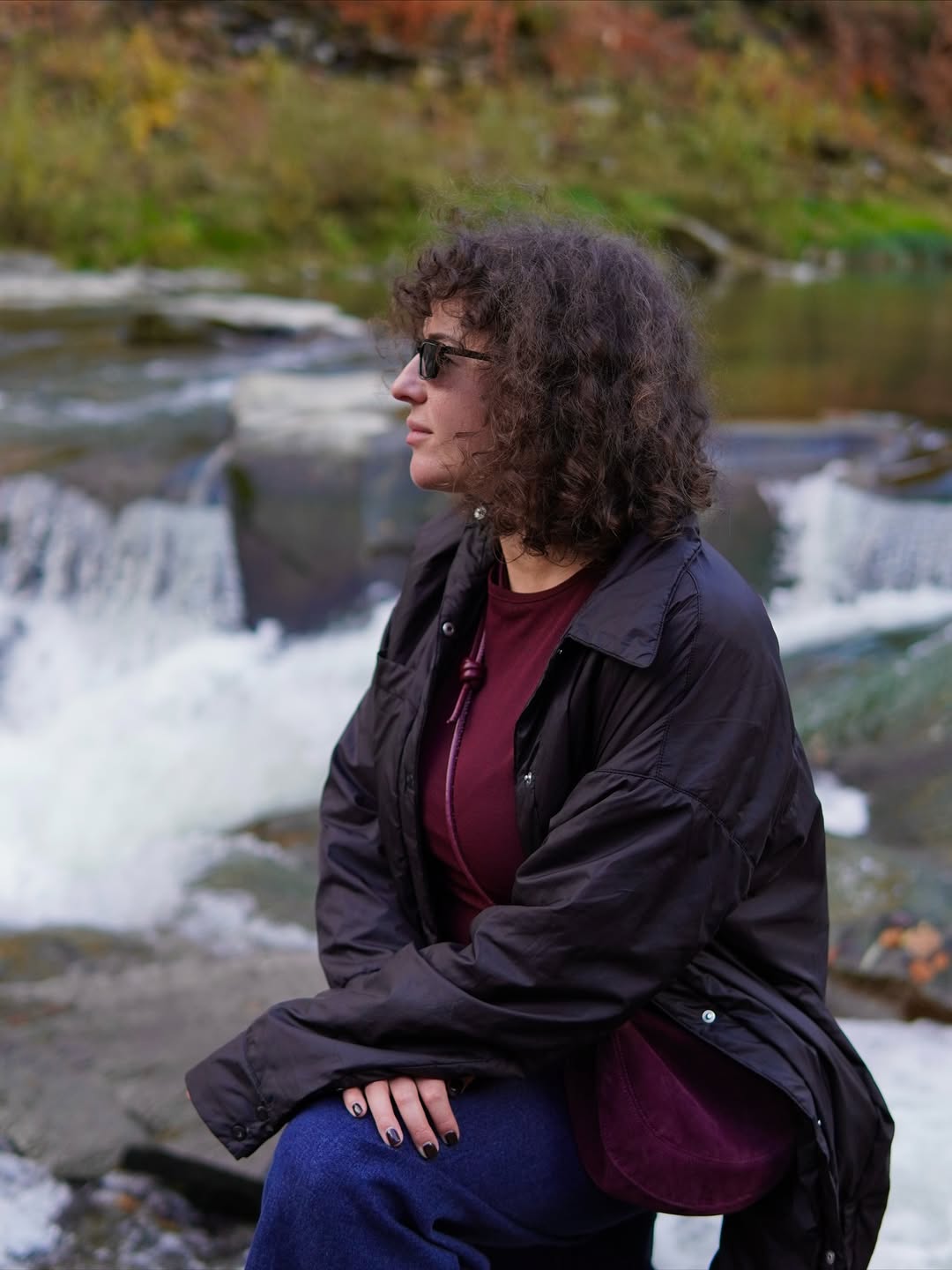 Myroslava outdoors by a waterfall